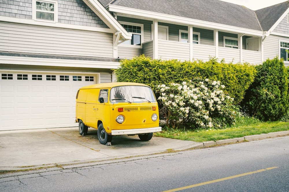 Yellow moving van at a residential move