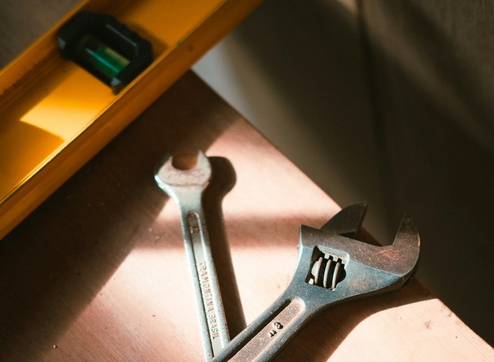 Plumbing wrenches and level ready for repair